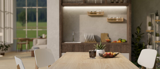 A wooden dining table in a luxury modern dining room with kitchen cooking space.