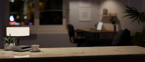 Copy space on a marble tabletop in a modern home office room at night.