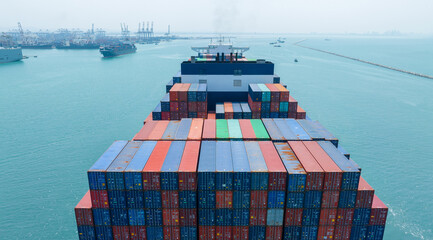Stern of large cargo container ship import export container box on the ocean sea on blue sky back ground concept transportation logistic and service to customer and supply chang