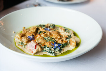 Potato gnocchi with crab meat and spinach