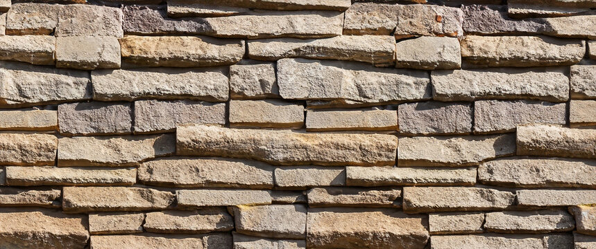 Seamless texture wall stone sandstone with shadows and deep texture. Clinker tiles or bricks on the wall in the form of wild stone