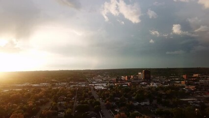 Aerial Ascending Forward Over Street Amidst Buildings Against Cloudy Sky At Sunset - Great Falls, Montana