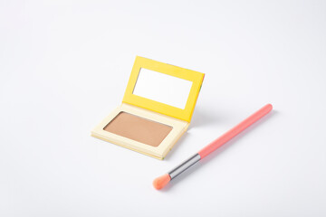 Beautiful eyeshadow palette with makeup brush lie on the table. Makeup product