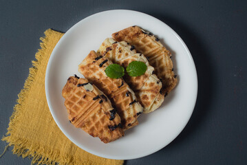 Croissant waffle or croffle on white plate. Croffle is Korean-influenced street food which become popular and trend in Indonesia now-days