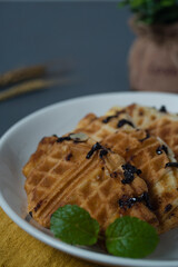 Croissant waffle or croffle on white plate. Croffle is Korean-influenced street food which become popular and trend in Indonesia now-days