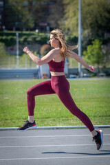 attractive girl running on running track