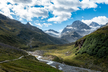 small path in the mountains with view towards a glacier and and the summit of Piz Buin	