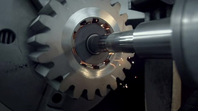 Industrial machinery is polishing the mechanism at the manufacturing facility. Industrial equipment is polishing the gear mechanism. Industrial machine is polishing the insides of the mechanism.