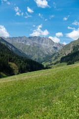 mountain landscape with view on alpine summits and blue sky	