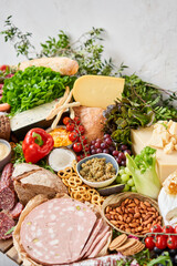 Parma sausage close-up. Table full of mediterranean appetizers, tapas or antipasto. Assorted Italian food set. Delicious snack on party or picnic time. Meat and cheese. Italian style banquet. 