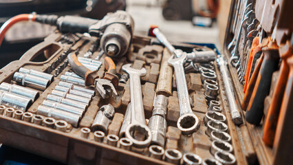 Fototapeta premium Dirty set of tools and wrenches close-up in box. Technical service station for car. Tool to repair the car or replace automotive spare parts, auto parts.