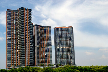 three majestic skyscraper apartment buildings on sunny day