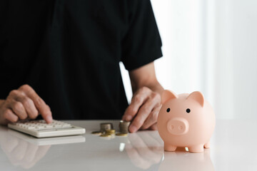 A Piggy Bank with a senior man calculates money and counts coins to show savings and deposits for investments, plans and retirement fund concepts.