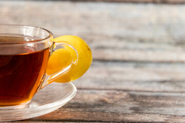 Close up shot of black tea with lemon and defocused background.