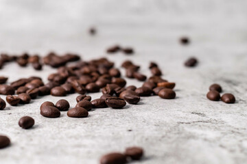 High angle shot of scattered coffee beans with defocused background.