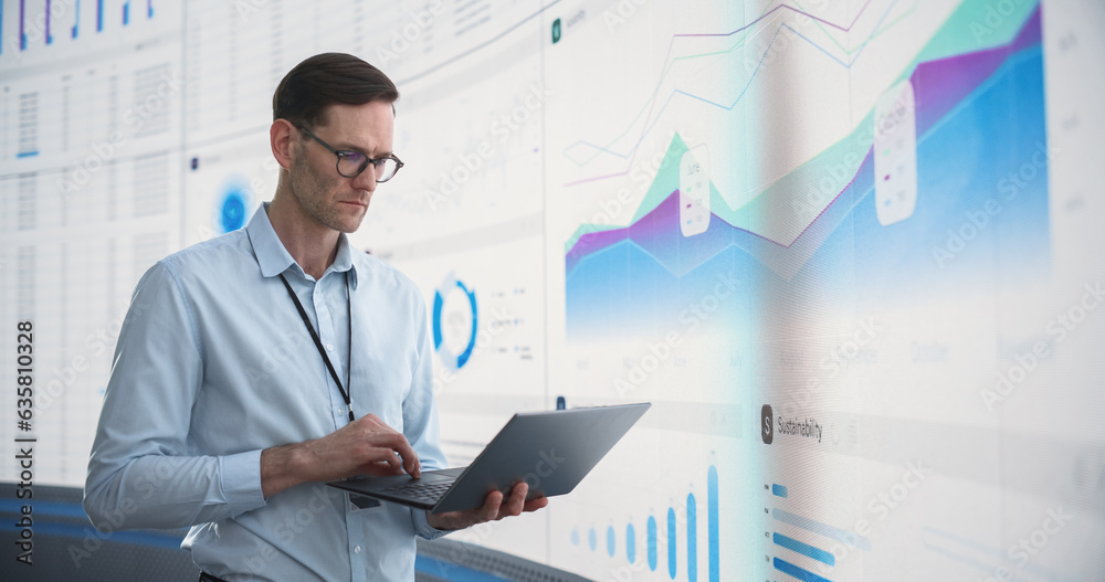 Aufkleber caucasian male business analyst with laptop computer standing next to big digital screen with graphs