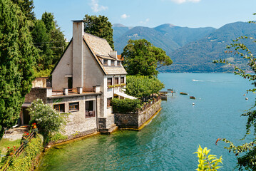 Fototapeta na wymiar Italy, Lake Lugano. View of the lake, mountains, houses standing above the lake.