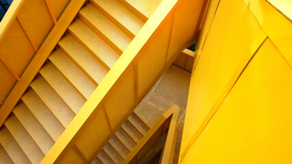iron yellow staircase outside contemporary building.