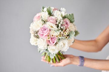 Bridal bouquet. The bride's . Beautiful of white flowers and greenery, decorated with silk ribbon.