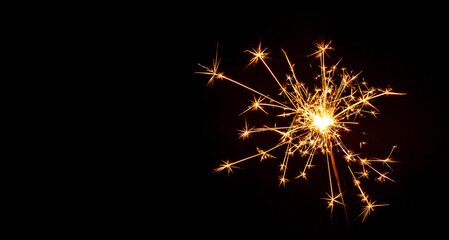 Sparks lit at Christmas and New Year party on black background.