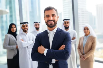 Fotobehang Beautiful arab middle-eastern women with traditional abaya dress and middle easter man wearing kandora standi in business office - Group of arabic muslim adults portrait in Dubai, United Arab Emirates © Hope