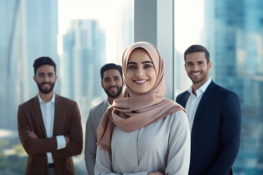 Beautiful Arab Middle-eastern Women With Traditional Abaya Dress And Middle Easter Man Wearing Kandora Standi In Business Office - Group Of Arabic Muslim Adults Portrait In Dubai, United Arab Emirates