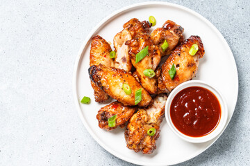 Chicken wings in bbq sauce.. Meat dish. Top view on white stone table.