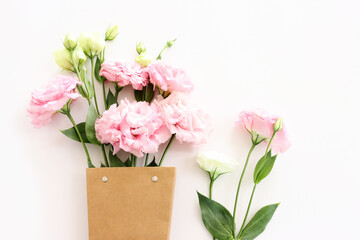 Top view image of pink flowers composition over white background