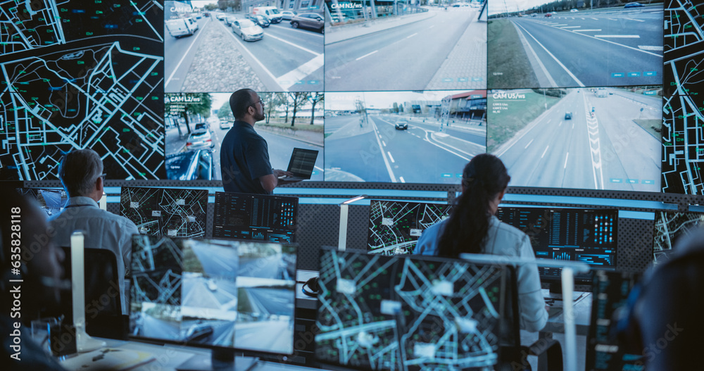 Poster Male Software Engineers Working on Laptop Next to a Big Screen in a Modern Monitoring Office with Live CCTV Footage with Traffic Situation. Monitoring Room With Big Data Engineers Work on Computers