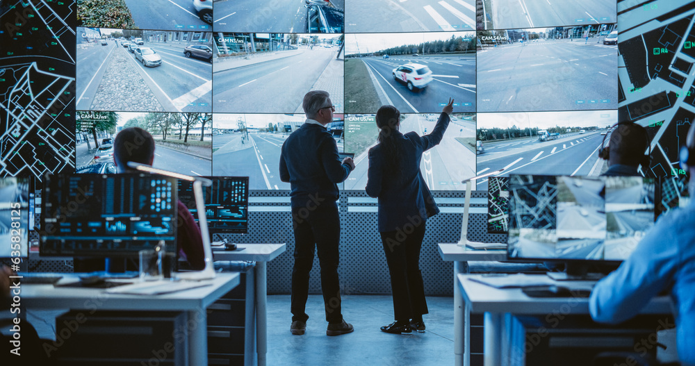 Leinwandbilder Two Diverse Male and Female Software Engineers Discuss Live Analysis Feed with City Road and Traffic Updates. Managers and Data Scientists Collaborate in a Modern Monitoring Office