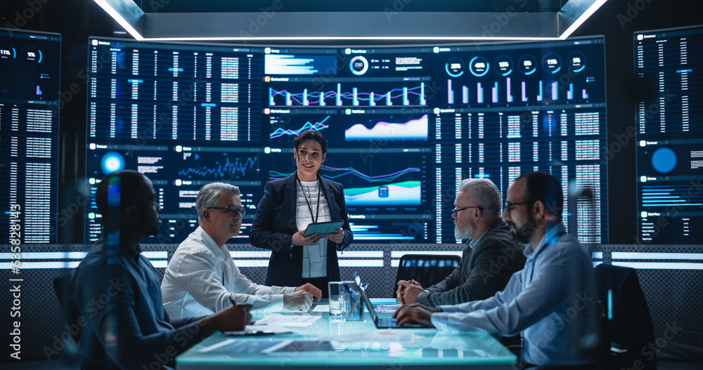 Fototapete Diverse Team Of Data Scientists and Software Developers Discussing Reports in Monitoring Room with Analytics Feed on Big Digital Screen. Female Leading Artificial Intelligence Company Board Meeting
