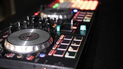 Fototapeta na wymiar DJ controller close up view in live performance night club dance music.