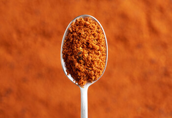 Sea buckthorn powder with seeds on a spoon