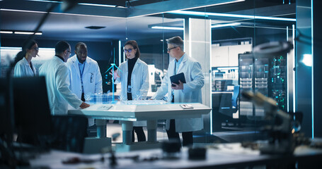 Diverse Team of Industrial Engineers Using Futuristic Hologram of Wind Turbine Prototype In Computer Powered Laboratory. Multiethnic Colleagues Looking VFX Projection. High Tech Concept.