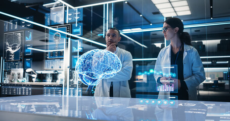 Two Neuroscientists Working With Computer-Powered VFX Hologram Of Human Brain And Nervous System In Futuristic Laboratory. Multiethnic Man And Woman Working On Solutions for Brain Tumor Prevention. - Powered by Adobe