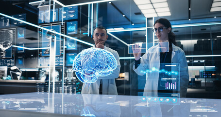 Two Neuroscientists Working With Computer-Powered VFX Hologram Of Human Brain And Nervous System In...