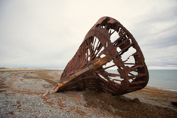 Skeleton of Shipwreck called Ambassador on the  coast of Magellan Strait, rusty warship wreck,...
