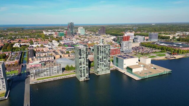 Aerial View on Skyline of Almere Netherlands, flying backwards. Almere was established in the mid-1970s and is currently the 7th largest city in The Netherlands.