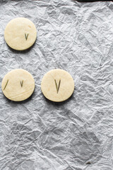 Top view of cut out rosemary sugar cookies, rosemary cookie on a white background, process of making rosemary sugar cookies