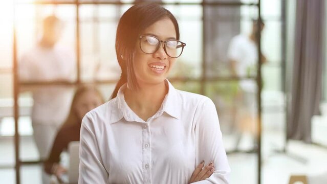 asian business woman with glasses looking away