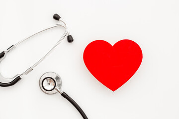Health care and insurance concept with red heart and medical stethoscope