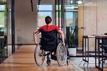 Fototapeta na wymiar A modern young businesswoman in a wheelchair is surrounded by an inclusive workspace with glass-walled offices, embodying determination and innovation in the business world