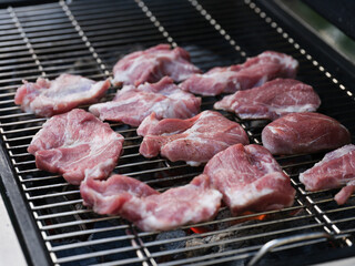 Organic pork meat cooking on a bbq grill