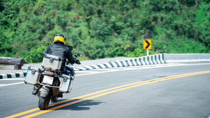 motorcycle on the road rides away. Travel on vacation, enjoy the nature trail. motorcycle in a sunny motorbike on the road riding.with sunset light. copyspace for your individual text.