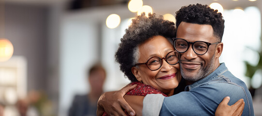 Smiling senior woman embracing her adult son against the backdrop of a living room