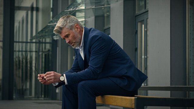 Sad upset worried employer pondering thoughtful leader unemployment frustrated stress pensive senior business man sorrowful think relax old mature businessman problem solution thinking tired in city