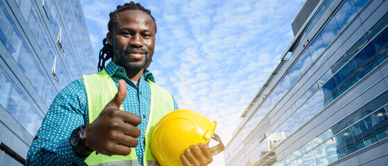 banner of positive and happy young black man civil engineer with thumb up looking at camera outdoors