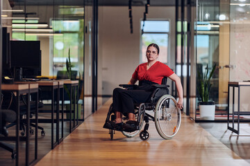 A modern young businesswoman in a wheelchair is surrounded by an inclusive workspace with glass-walled offices, embodying determination and innovation in the business world