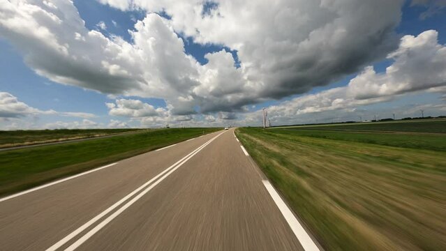 POV driving on oblique bend in the road in the flevopolder in the netherlands