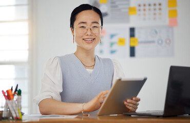 Portrait of Asian woman at desk with smile, tablet and research for business website, online report or social media. Internet, digital app and businesswoman in office with web schedule and confidence